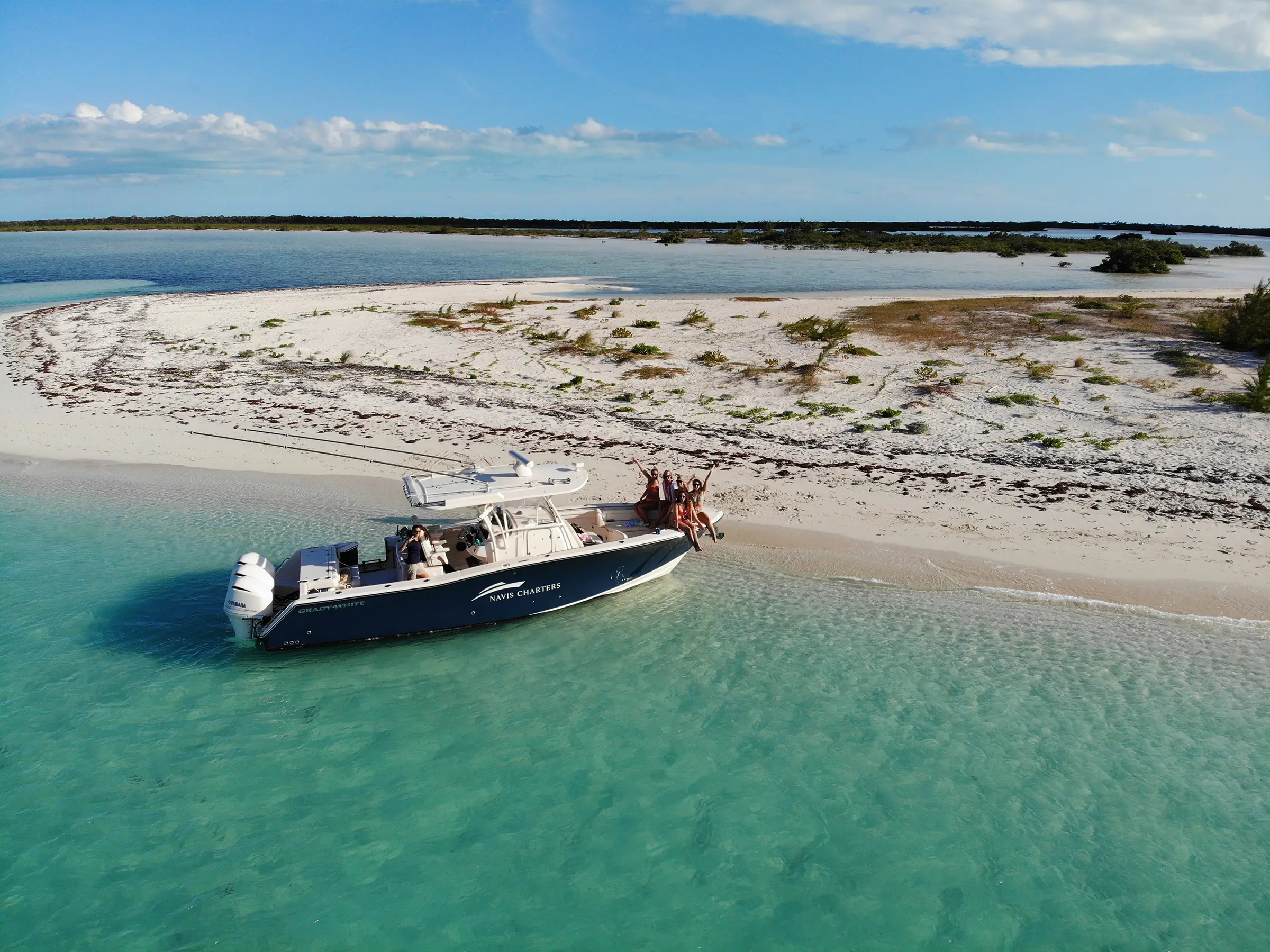 Sweet T, a 36 ft Grady-White, anchored off a white sand beach